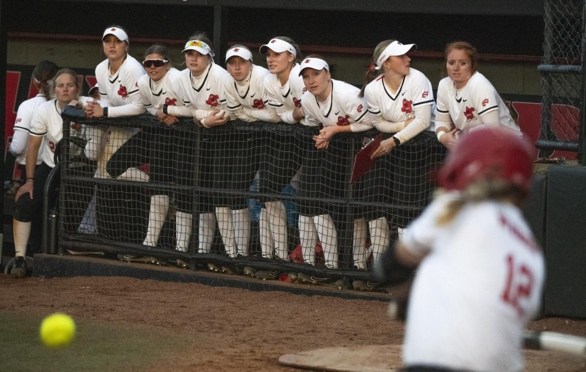 The WKU softball team watches in-fielder Sophie Weber (12) bat during Western Kentucky University's game against Southern Illinois University on Sunday, March 3, 2024. 