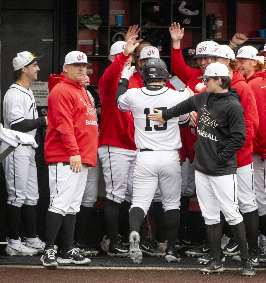The WKU baseball team celebrates Brady Browning's (15) home-run during Western Kentucky University's games against University of Wisconsin, Milwaukee on Friday, March 8, 2024. 