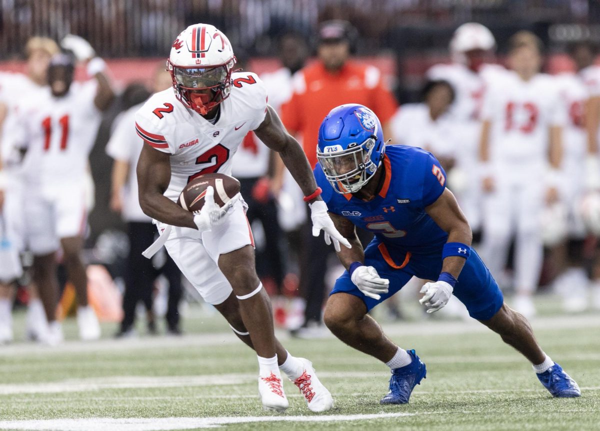 Redshirt senior running back Davion Ervin-Poindexter (2) carries the ball under defense during the game between WKU and Houston Christian on Saturday, Sept. 9, 2023. WKU won 52-22. 