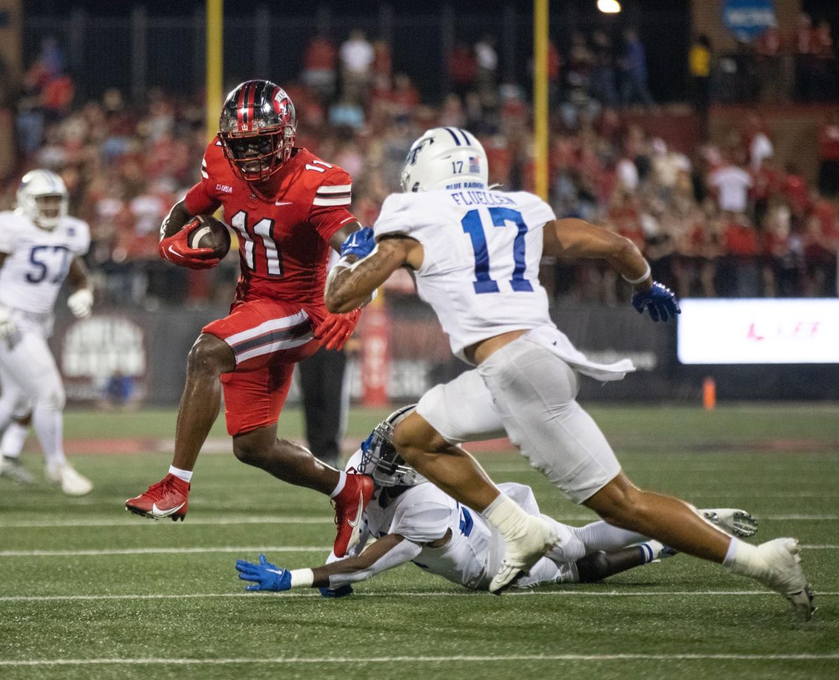 Wide Receiver Malachi Corley attempts to dodge two MTSU defenders during a home game at L.T Smith Stadium in Bowling Green on Thursday, Sept. 28, 2023.