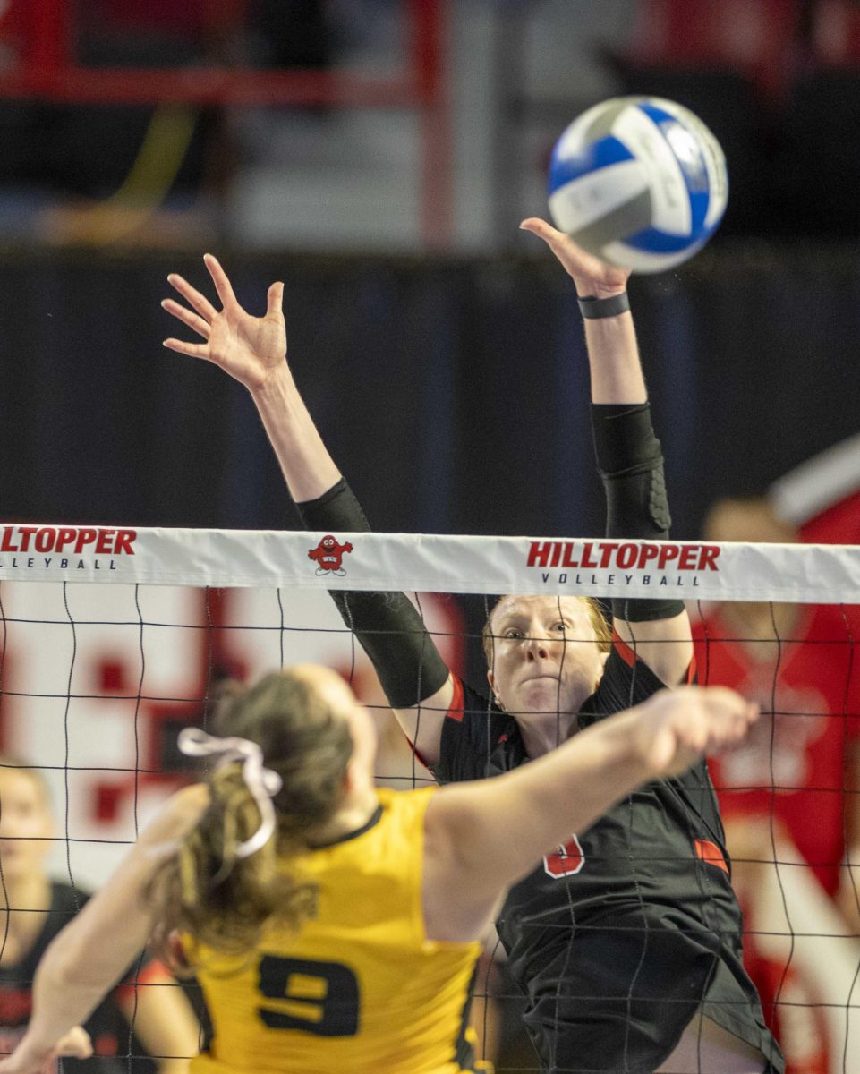 Western Kentucky University outside hitter Kaylee Cox attempts to block a ball during a match against Kennesaw State University at Diddle Arena on Saturday, Oct. 5, 2024.  