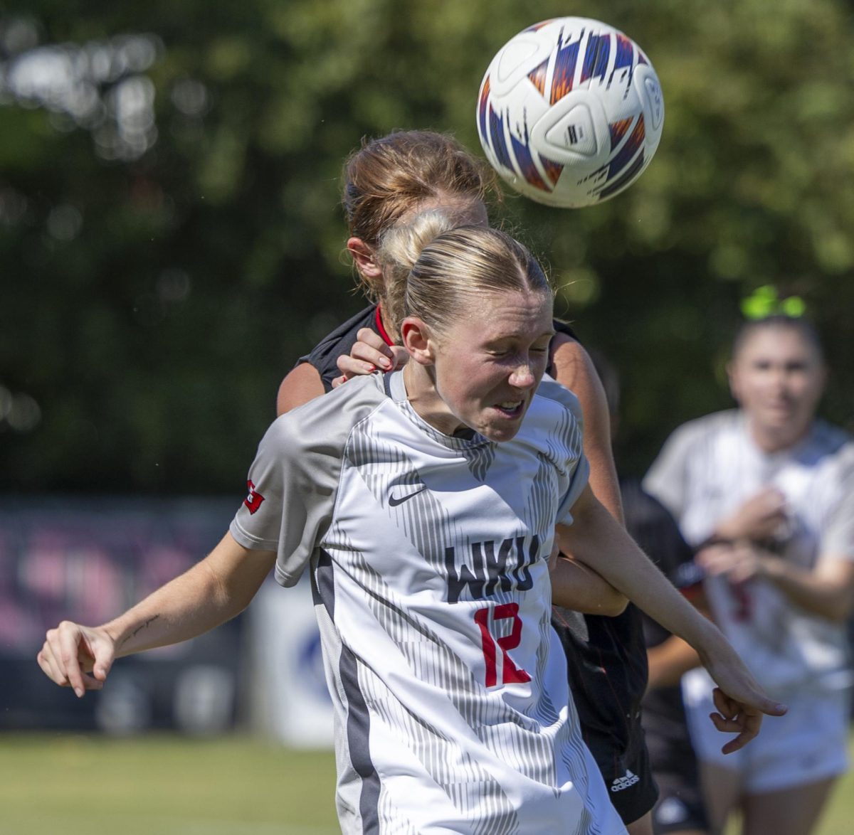 Western Kentucky University midfielder Camryn Davis (12) bumps the ball toward her teammates with her head during a match against Jacksonville State University at the WKU Soccer Complex on Sunday, Oct. 6, 2024.  