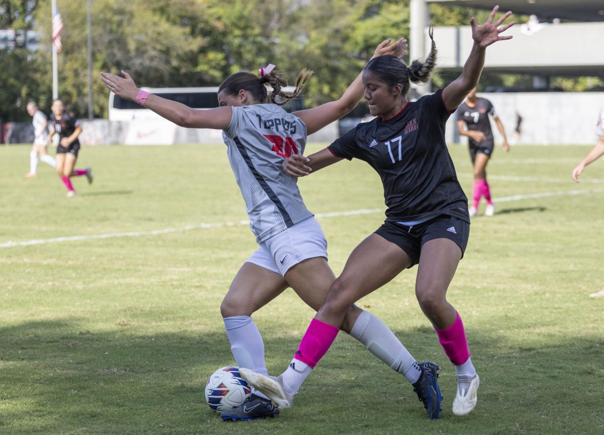 Jacksonville State University forward Nancy Almanza (17) and Western Kentucky University midfielder Georgia Liapis (20) throw their hands up as they fight for the ball during a match at the WKU Soccer Complex on Sunday, Oct. 6, 2024.