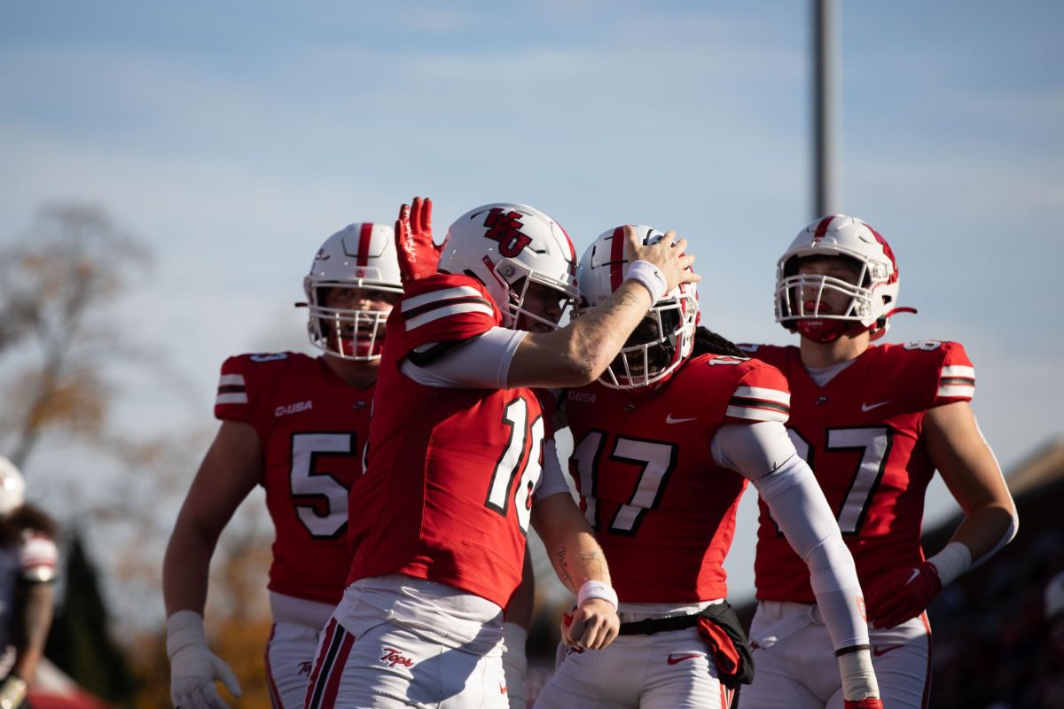 Quarterback Austin reed (16) middle celebrates his touchdown with wide receiver Dalvin Smith (17) during WKU’s homecoming game against New Mexico State University at L.T Smith Stadium in Bowling Green on Saturday, Nov. 11, 2023.  