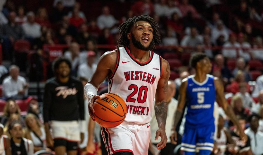 WKU guard Dayvion McKnight slowly dribbles across the court in celebration as the game against MTSU comes to end at Diddle Arena in Bowling Green, Ky. on Feb. 9, 2023. WKU won 93-89.