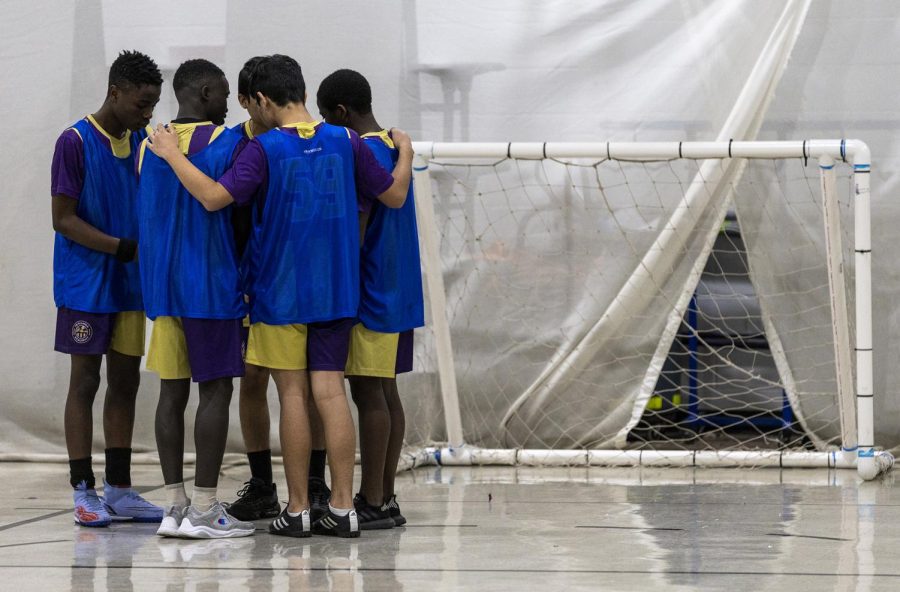 The Avengers team gathers before the start of Teranga Academy's final soccer tournament match at the Bowling Green Learning Academy.