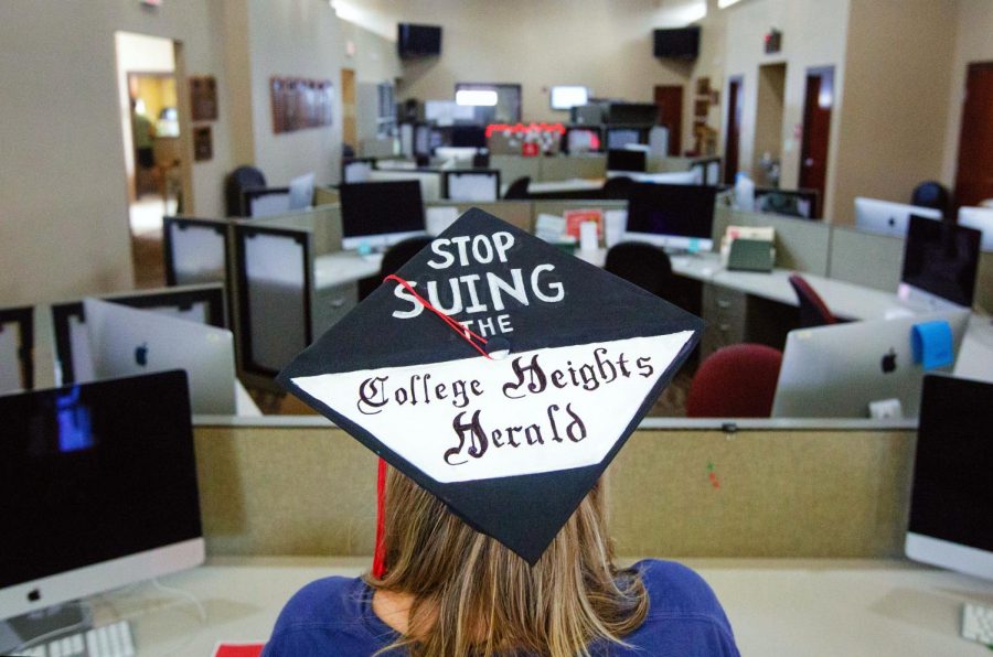 A student shows off their graduation cap art in the Adams-Whitaker Student Publication Center located on Western Kentucky University’s campus on May 10, 2019.