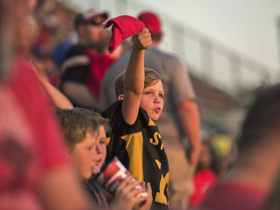 Ayden Horn, 10, cheers on the Hilltoppers at the homecoming game on Saturday in the Houchens Industries–L. T. Smith Stadium. Horn attended the game with his teammates from the Steelers, an elementary school football team, named after the NFL football team, at Clarkson Elementary in Grayson County.