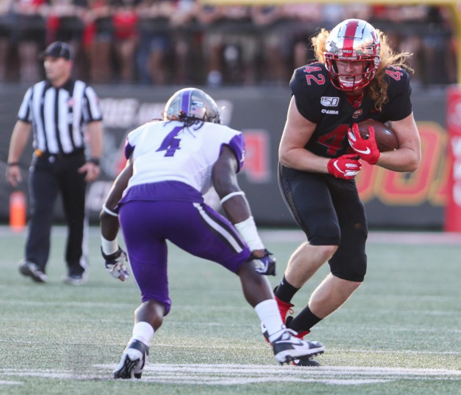 WKU Hilltoppers redshirt junior tight end Kyle Fourtenbary (42) attempts to pass before getting tackled by Central Arkansas Bears defensive back Juan Jackson (4) during WKU’s loss 35-28 against Central Arkansas Bears in Houchens Smith Stadium on August 29, 2019.