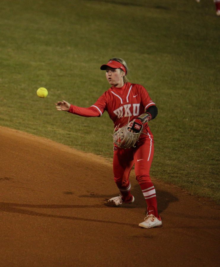WKU Softball's utility senior Jordan Riggs (9), throws to first base during thier matchup with the Bellarmine University Softball team at the WKU Softball Field on Feb. 18.
