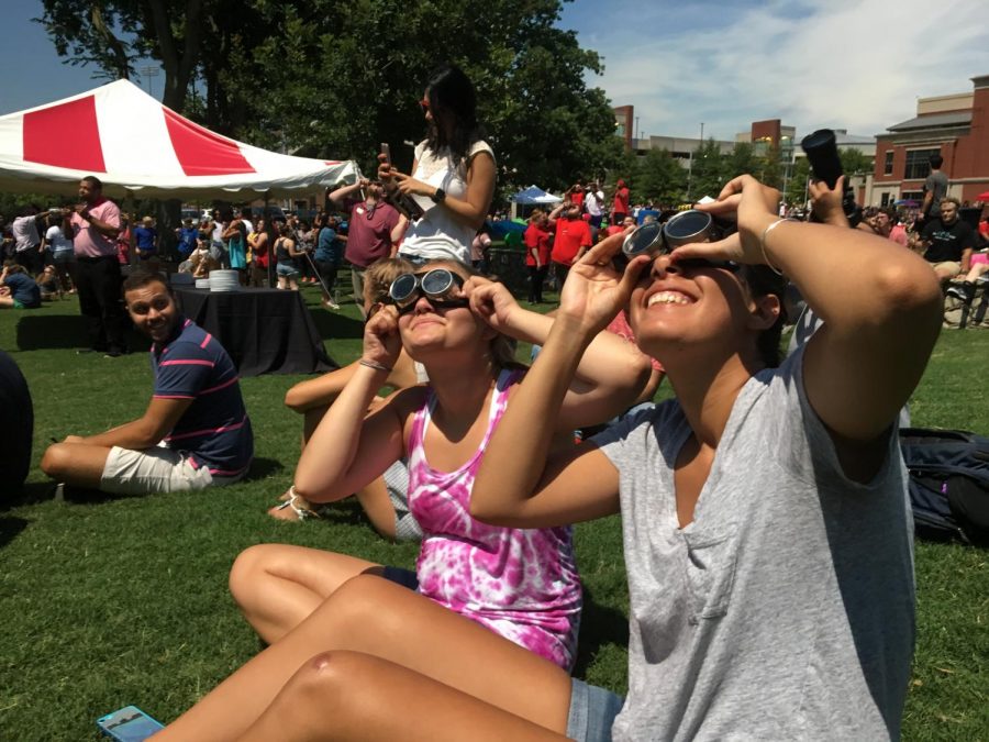 Centre College sophomore Zahra Ortiz (right) watches the eclipse using welding goggles ordered by her dad, an ophthalmologist, with her roommate, Reagan Lynn. They originally planned on traveling to Hopkinsville for the eclipse but came to WKU to avoid traffic.
