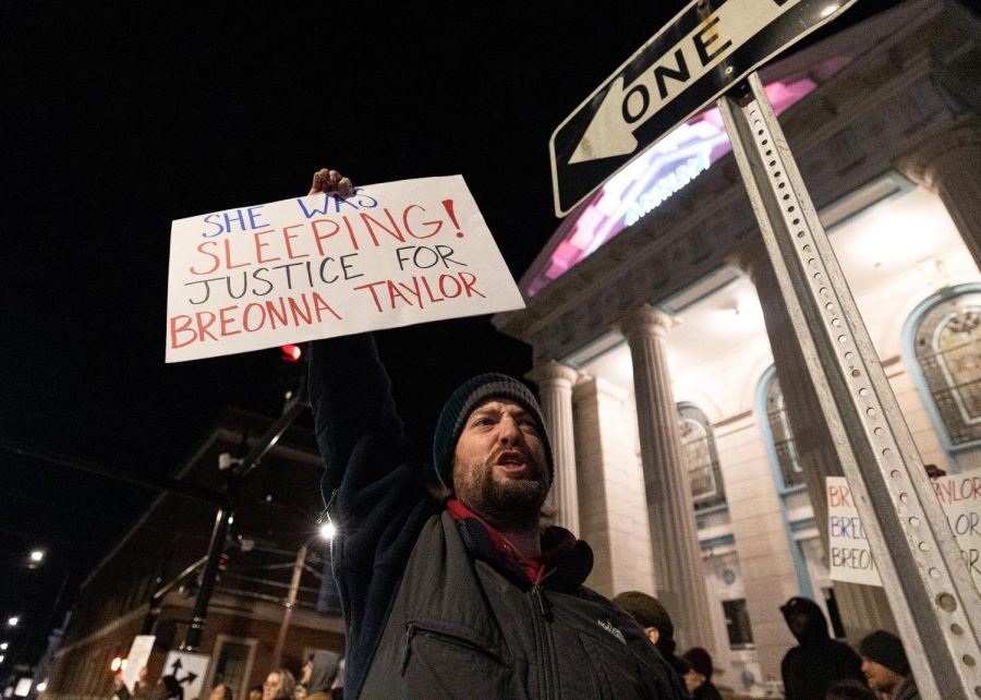 Demonstrator Michael Greene holds a sign during the BG Freedom Walkers second “Keep Breonna Taylor’s Name & Legacy Alive” protest and march on Monday evening, Jan. 23, 2023 in downtown Bowling Green, Ky. Greene, alongside his fellow protestors, marched from Warren County Public Library to the Anna’s Greek Restaurant, less than a block away. There, six days earlier, Jonathan Mattingly—one of the Louisville Metro Police officers involved in Breonna Taylor’s killing—held a book-promotion with the Republican Women’s Club, after his engagement was canceled at the previous venue. 