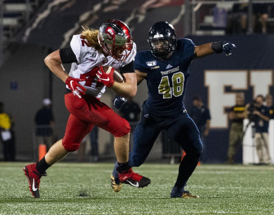 WKU tight end Kyle Fourtenbary (42) rushes the ball past FIU linebacker Josh Powell (48) in the Hilltoppers’ 20-14 win at Riccardo Silva Stadium in Miami, Fla. on September 7, 2019.