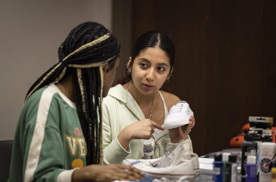 Freshman international affairs major Vanessa Ocampo (right) talks through her shoe design with freshman political science major Haley Rankin during the Walk in Your Excellence event, put on by Blaq Art Nouveau inside DSU on Wednesday, Feb. 22, 2023.