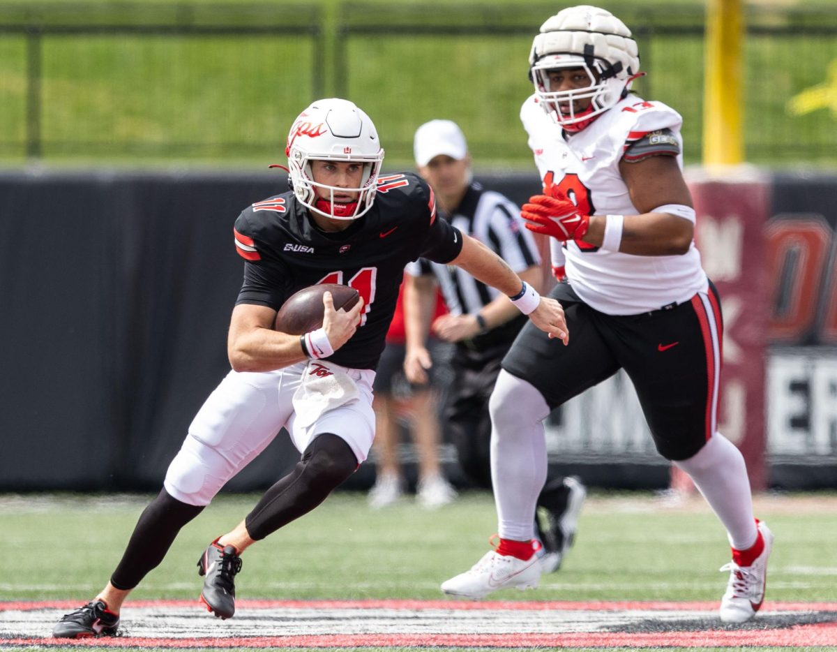 Quarterback Tucker Parks (11), left, runs the ball during the Red & White Spring Showcase at L.T Smith Stadium in Bowling Green on Saturday, April 20, 2024.
