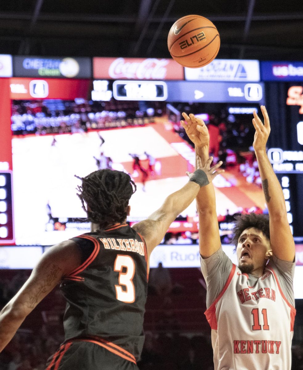 Forward Dontaie Allen (11) goes for a three-point field goal during the first half of WKU's game against Sam Houston on Thursday, Feb. 1.