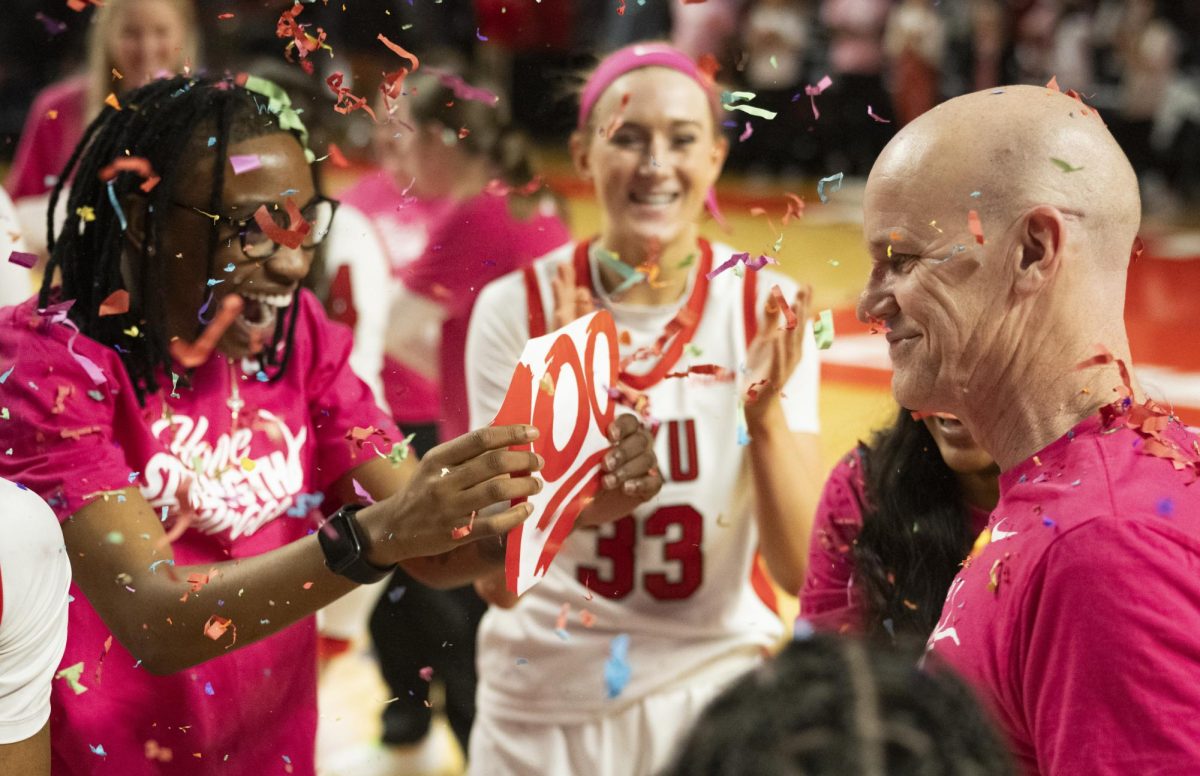 The WKU Lady Toppers celebrate their head coach Greg Collin's 100 career win on Wednesday, Feb. 7.