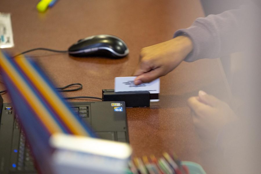 A PFT desk attendant swipes a student's WKU ID on Sunday, Sept. 9, 2018.