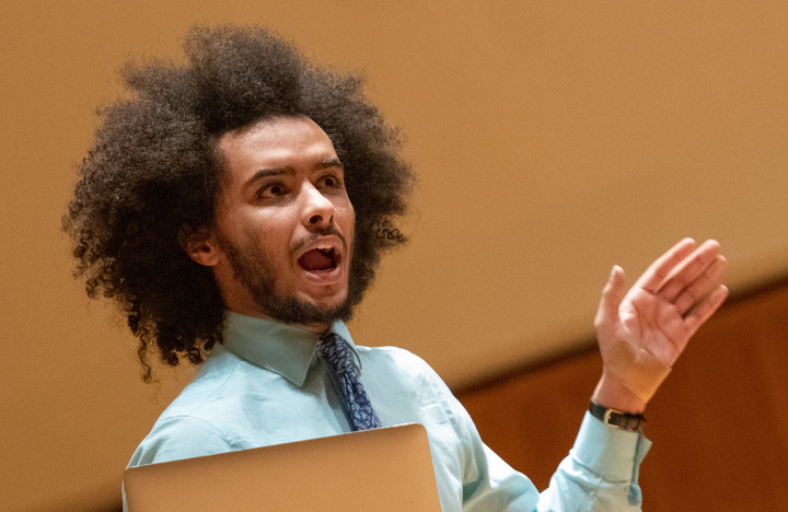 Senior Andre Swai reads a part of his Lincoln Douglas debate case during the WKU Forensics Black Excellence Showcase on Wednesday, Feb. 8, 2023 in the FAC recital hall.
