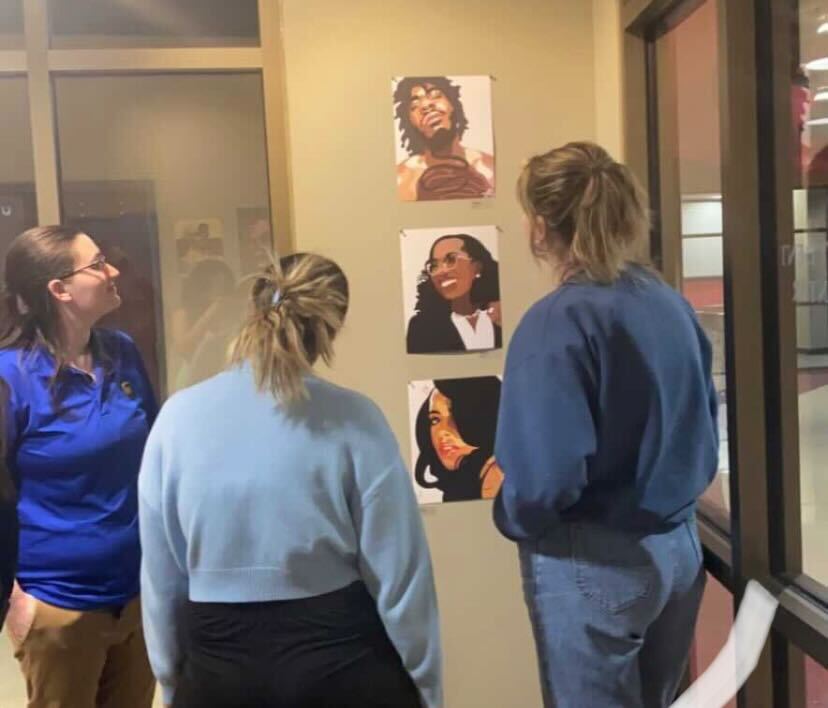 Students viewing art at the "Melanin" gallery on Tuesday, Feb. 7.
