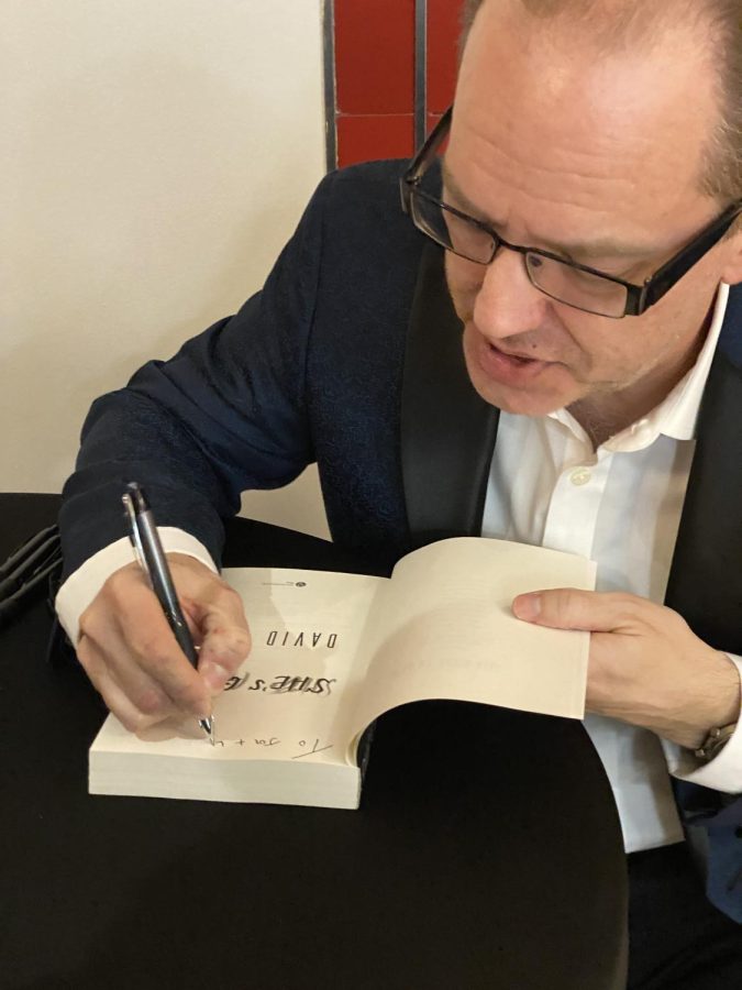 David Bell, professor and interim director of MFA Program in the English department, signs copy of newest book at the launch for "She's Gone.at Capitol Arts Theatre in downtown Bowling Green.