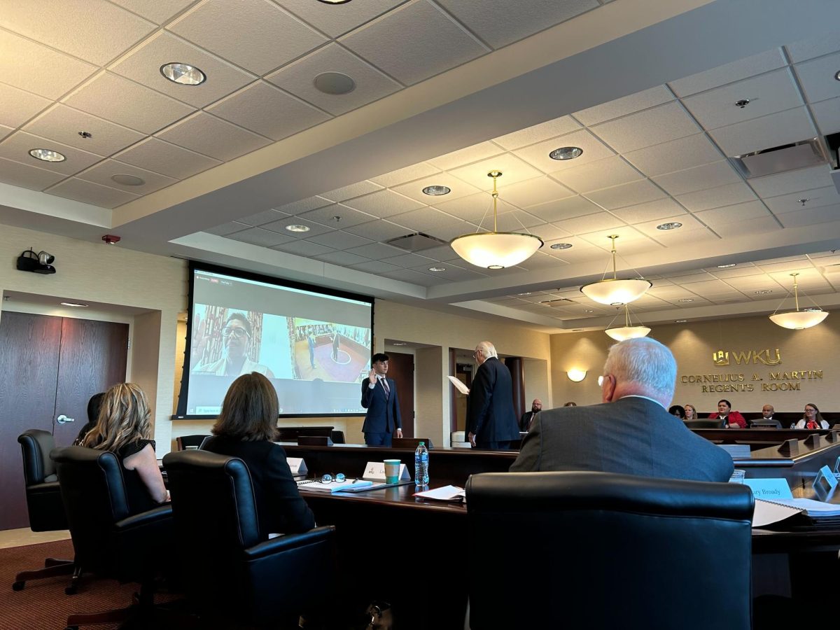 Student regent Sam Kurtz is sworn in at the third quarterly Board of Regents meeting on Friday, Aug. 11.