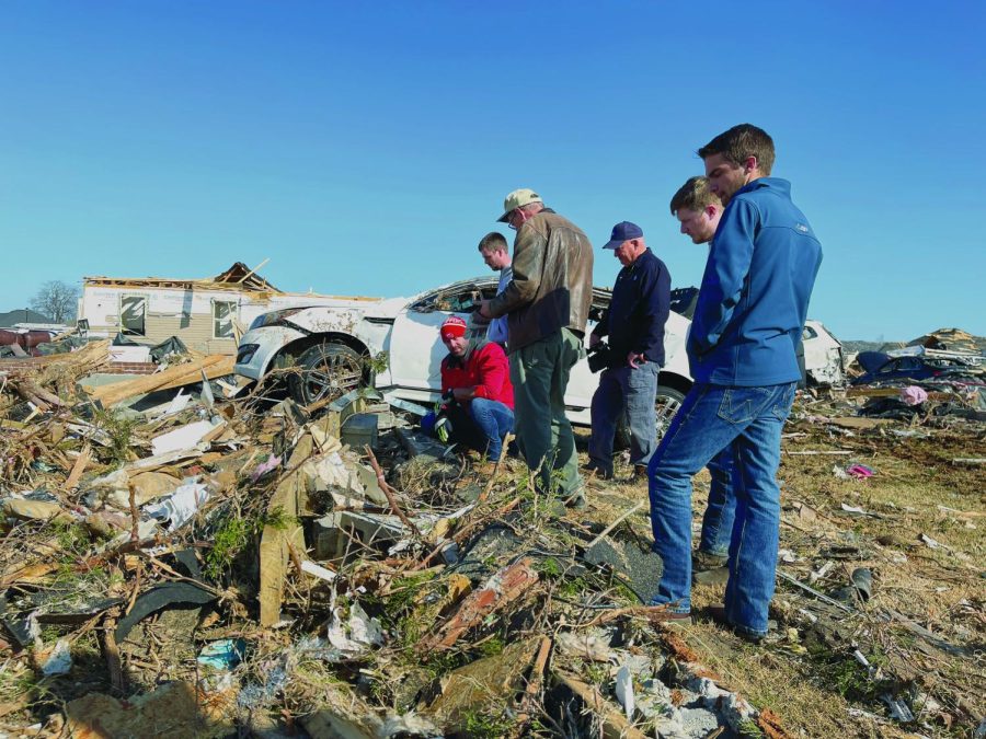 WKU Engineering faculty Jason Wilson (left), National Weather Service of Louisville Meteorologist-in-Charge Gordon (center) and a group of WKU meteorology students investigate debris in the
Moss Creek Neighborhood.