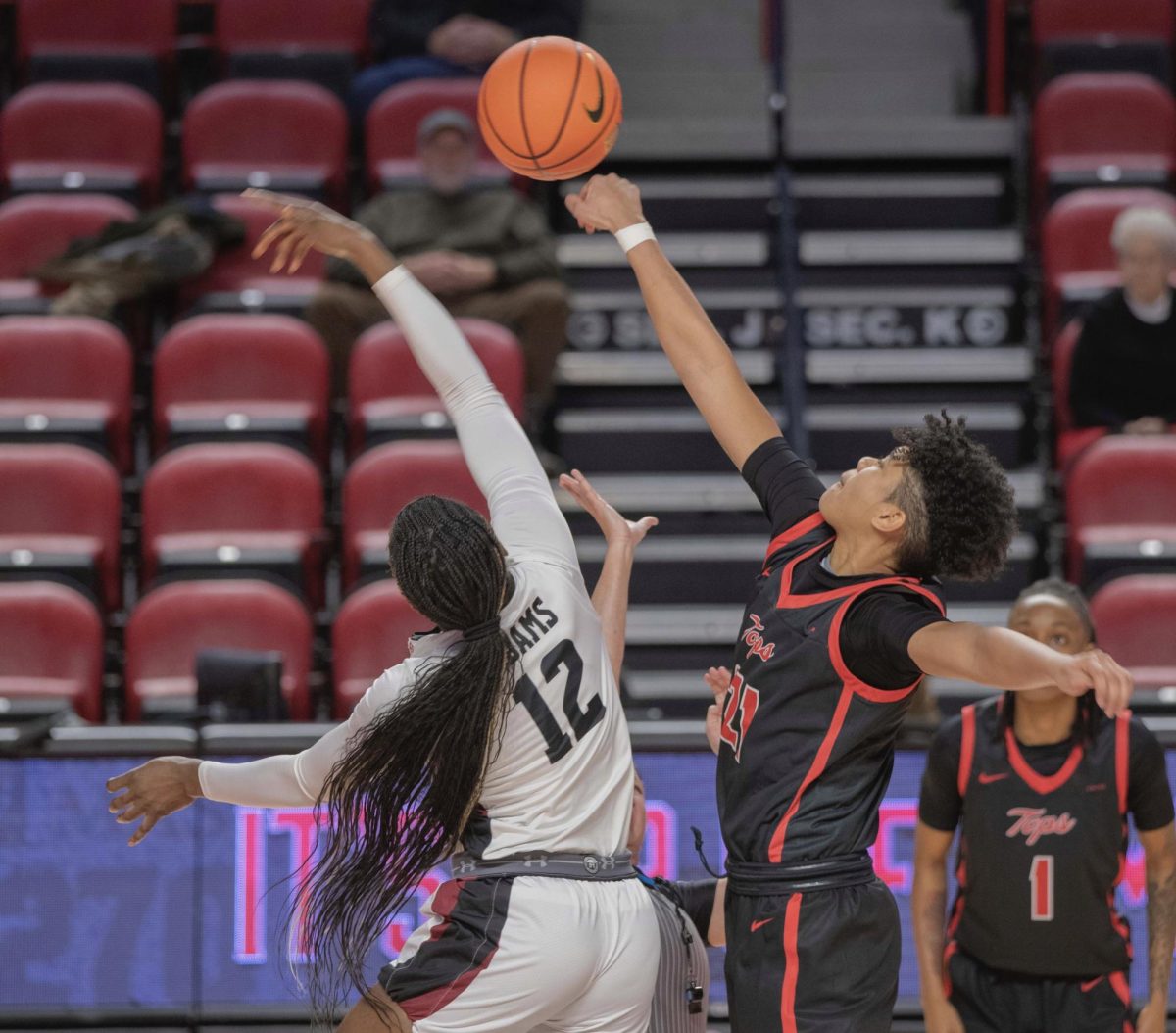 Forward Odeth Betancourt (21), right, jumps for the ball during the tipoff against New Mexico State University's Ene Adams (12) on Thursday, Jan. 18, 2024. 
