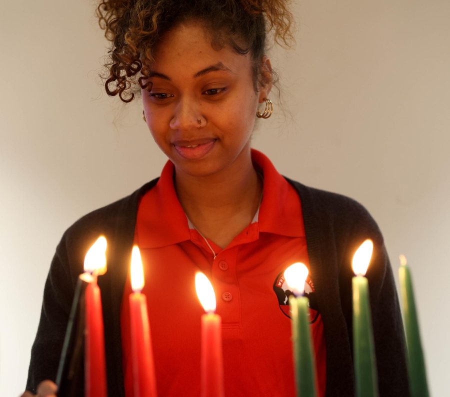 Tylia Standard lights the candle for "Kuumba" during the Kwanzaa celebration at Mahurin Honors College at WKU on Thursday, Dec. 1, 2022.