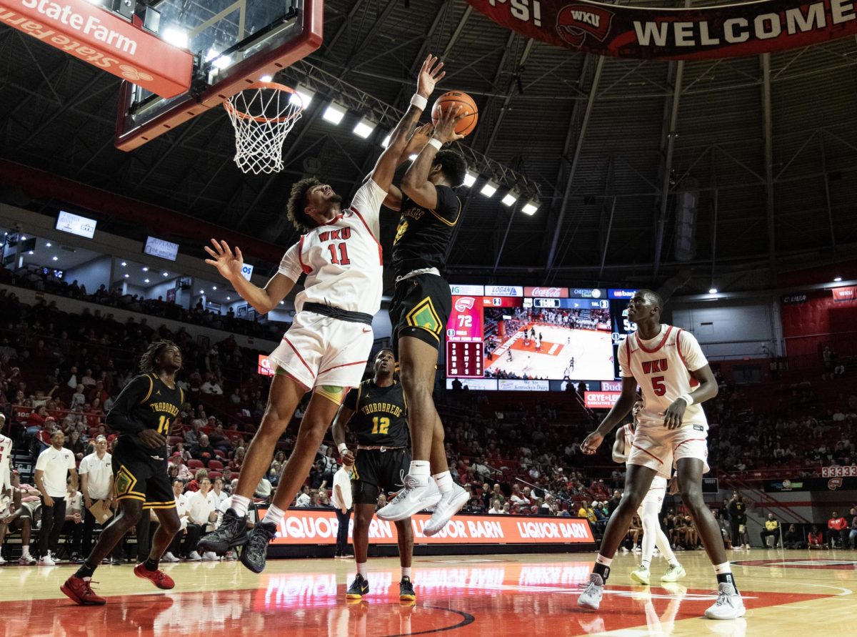 Redshirt senior guard/forward Dontaie Allen (22) attempts to stop a pass from a Kentucky State player during the November 19 game at E.A. Diddle Arena.