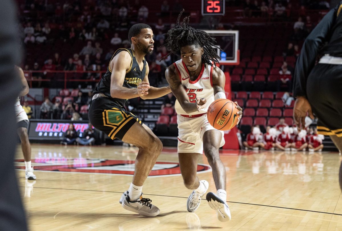 Junior guard Don McHenry (2) drives the ball past a Kentucky State player during a WKU home game on November 19, 2023.