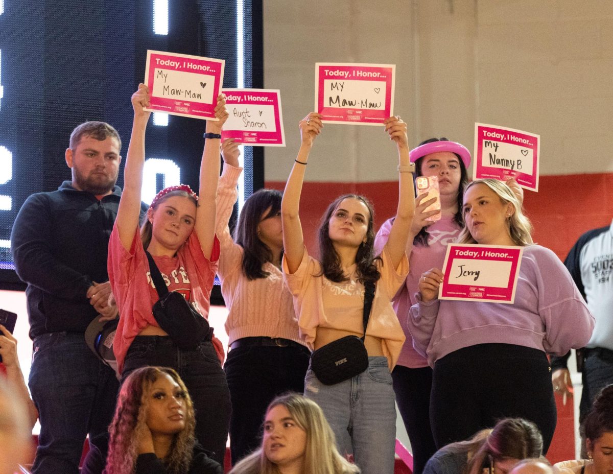 Members of the student section hold up signs in honor of loved ones who have had cancer during a home game against the Florida International University in the Diddle arena on Thursday, Jan. 25, 2024. 