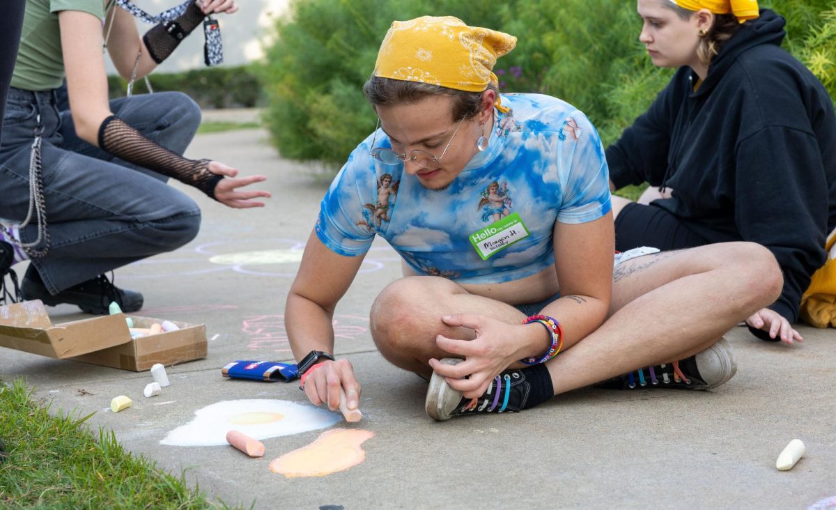 Maysn Hughes draws with chalk at Pride on the Lawn at Western Kentucky University on Sept. 7, 2023.
