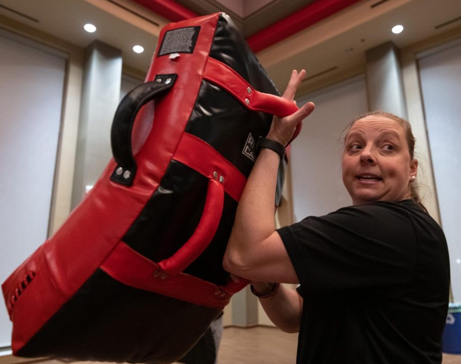 WKUPD Officer Melissa Bailey demonstrates how to use strike pads during a self-defense training session with members of Why Knot Us Too on Wednesday, March 8, 2023 in DSU Nite Class.