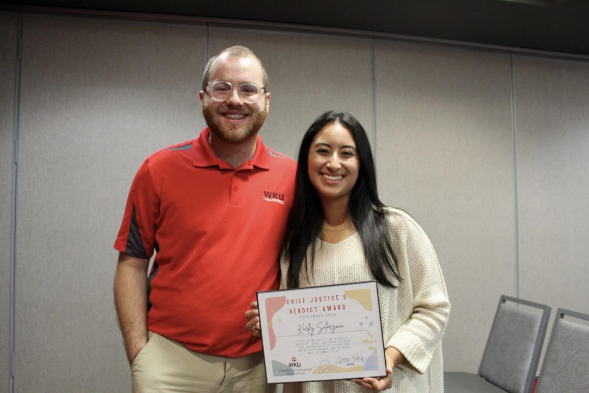 Karley Soloranzo receives Chief Justice's Verdict Award from Isaac King on Wednesday, Oct. 18.