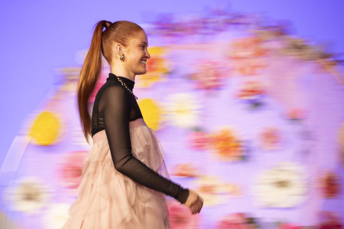 Fashion model Abby Gubbins struts across the floral decorated stage at the closing of the “Life Is Your Runway: Pure Imagination” Fashion Show at Western Kentucky University’s Downing Student Union auditorium in Bowling Green, Ky. Feb. 26, 2024. 
