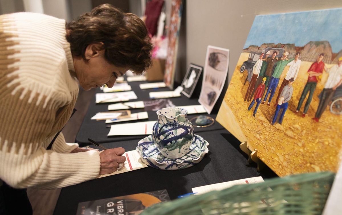 Syrian-American Huda Melby places a bid for a decorative vase during BGKY4Palestine’s Women’s Day Charity Auction for Palestine at the Islamic Center of Bowling Green, on Mar. 8, 2024. “This is a good cause for Gaza’s children and all who are struggling in Palestine,” Melby said. 