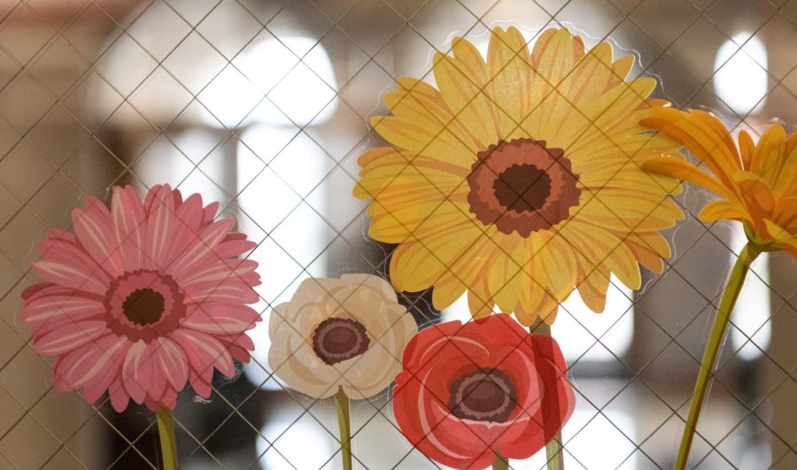 Spring-themed sticker decorations are seen on a window Tuesday, March 21, 2023 at the Student Success Center in Gary Randell Hall for the CEBS Spring Celebration. 