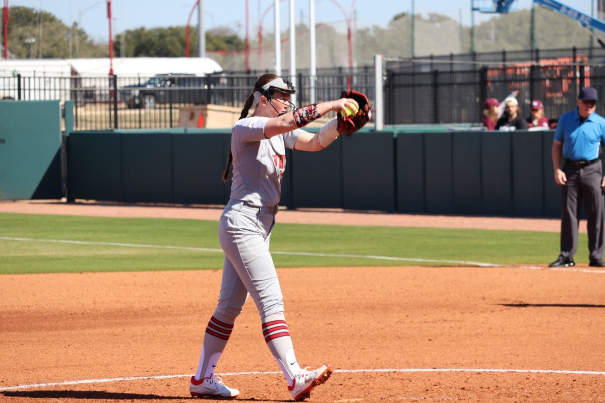 Katie Gardner, with her left arm wrapped, pitching through injury during the 2022 season