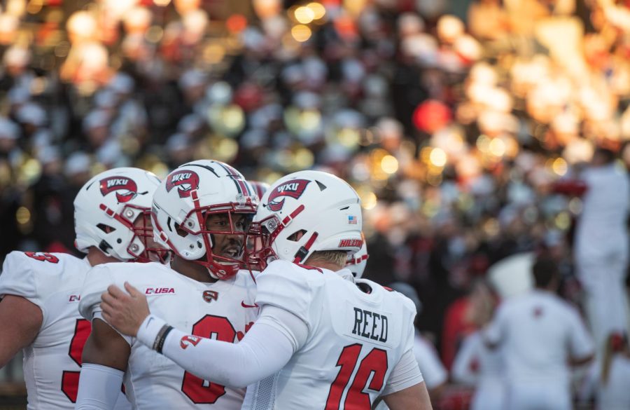 Western Kentucky University Hilltoppers quarterback Austin Reed (16) celebrates a touchdown with his teammates during their match against the Troy University Trojans Saturday evening, Oct. 1, 2022 on Jimmy Feix Field on the WKU campus in Bowling Green, Ky. Hilltoppers fell to the Trojans 34-27.