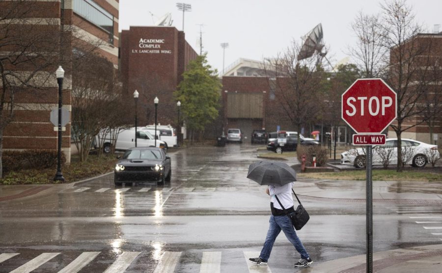 A student walks through driving rain ahead of a possible tornadic storm system affecting the south-central Ky. Region on Friday, March 3, 2023. WKU has cancelled all classes from 11:00 am CST onward due to the possibility of dangerous weather. 