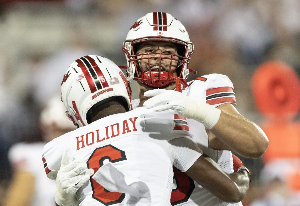 Sophomore wide receiver Jimmy Holiday (6) and junior offensive lineman Mark Goode (76) celebrate after a touchdown during WKU’s game against Houston Christian on Saturday, Sept. 9, 2023. WKU won 52-22.