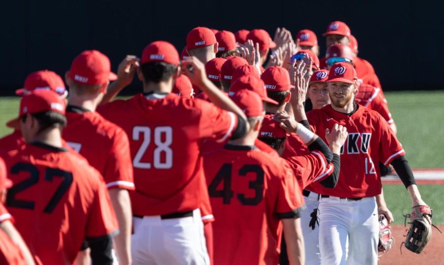 WKU Hilltoppers run a post-game ritual after the first round of a double-header against the NIU Huskies Saturday, March. 4, 2023 at Nick Denes Field. WKU won the first match 9-8.