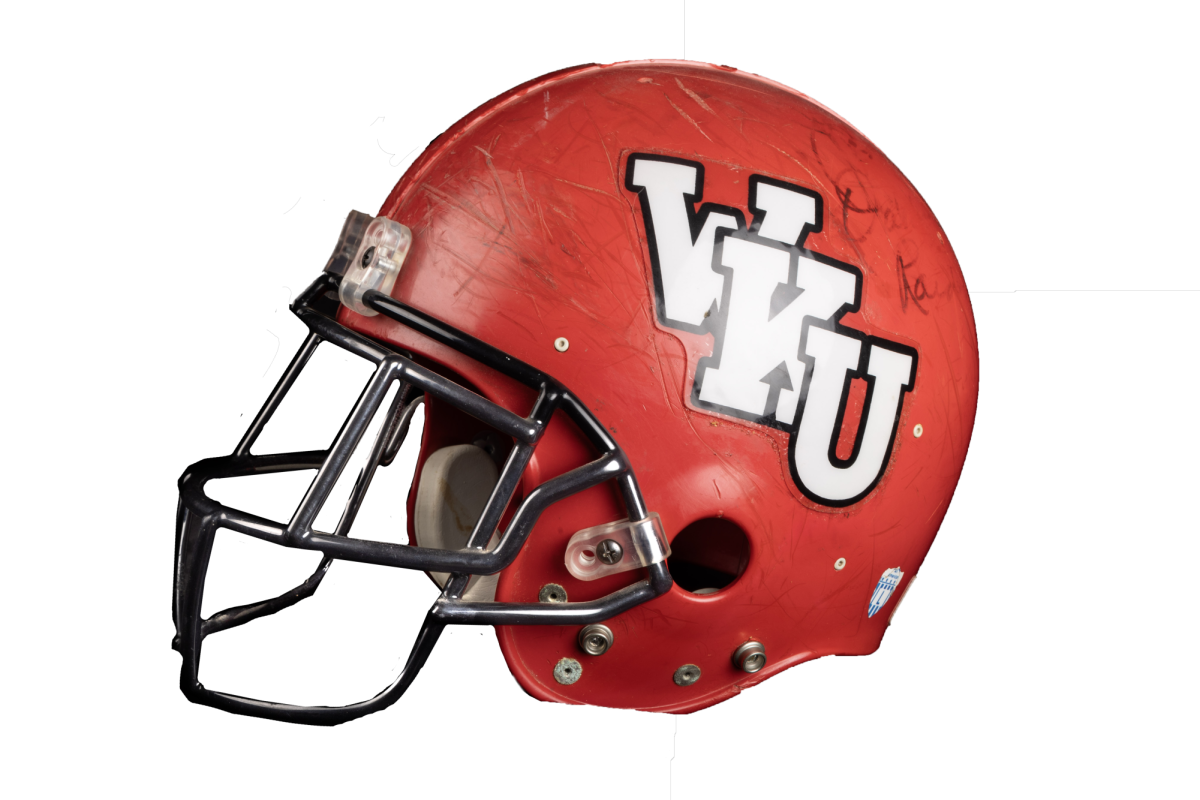This helmet was signed by Joe Bugel, who played for WKU from 1960-1963 before joining the Hilltoppers coaching staff as a graduate assistant. Bugel went on to coach in the NFL and helped lead the Washington Redskins to three Super Bowl wins. He also coached for the Detroit Lions, the Houston Oilers, and the San Diego Chargers. He aalso served as a head of the Phoenix Cardinals and Oakland Raiders. This helmet was made for a team in the mid 1990's that Bugel signed. Bugel died in 2020. (Sue Strader)